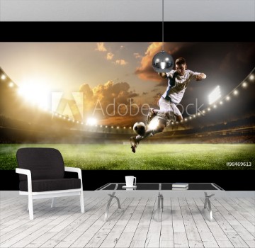 Picture of Soccer player in action on sunset stadium panorama background